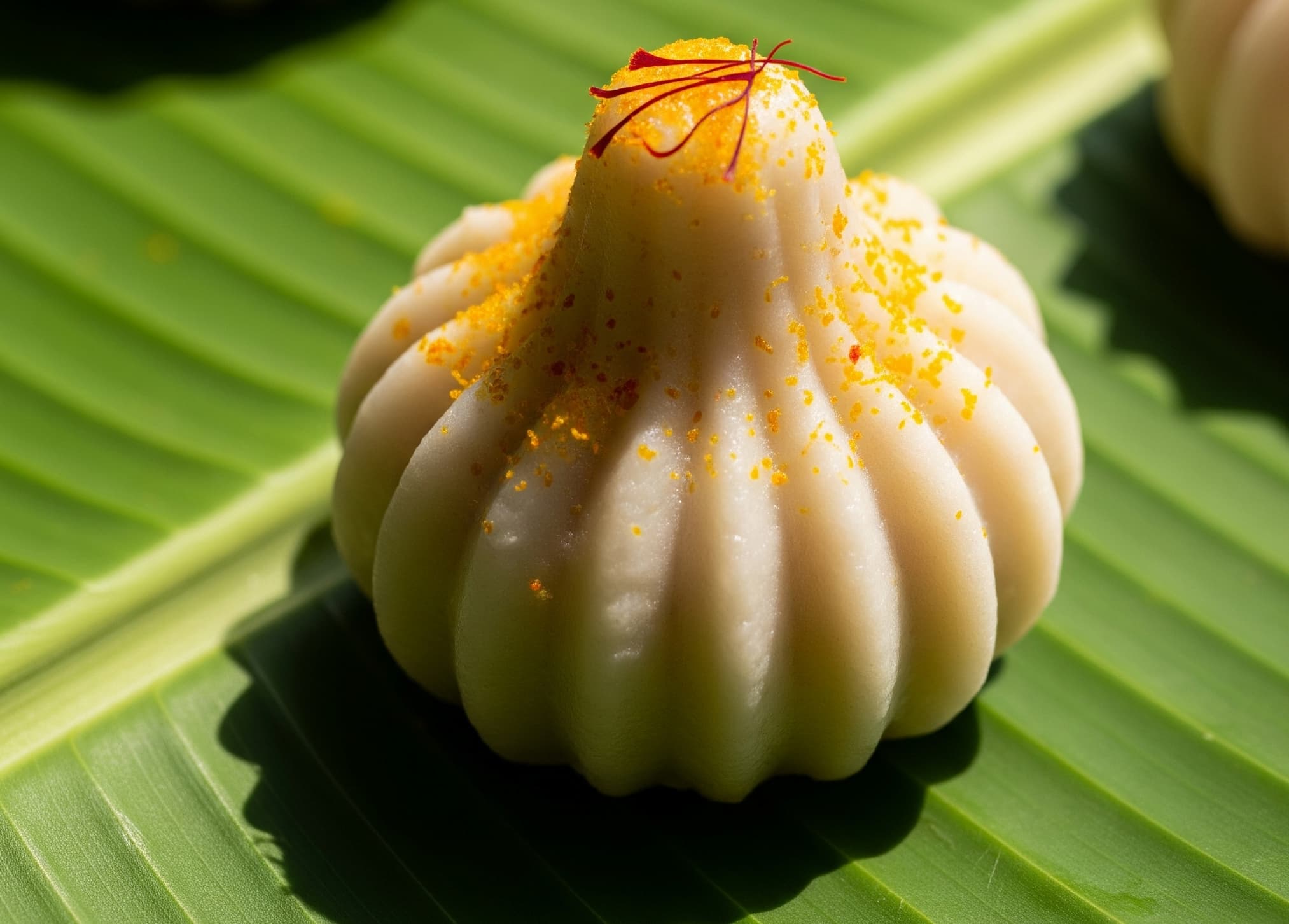 Traditional Ukadiche Modak with Kesar on Banana Leaf for Ganesh Utsav